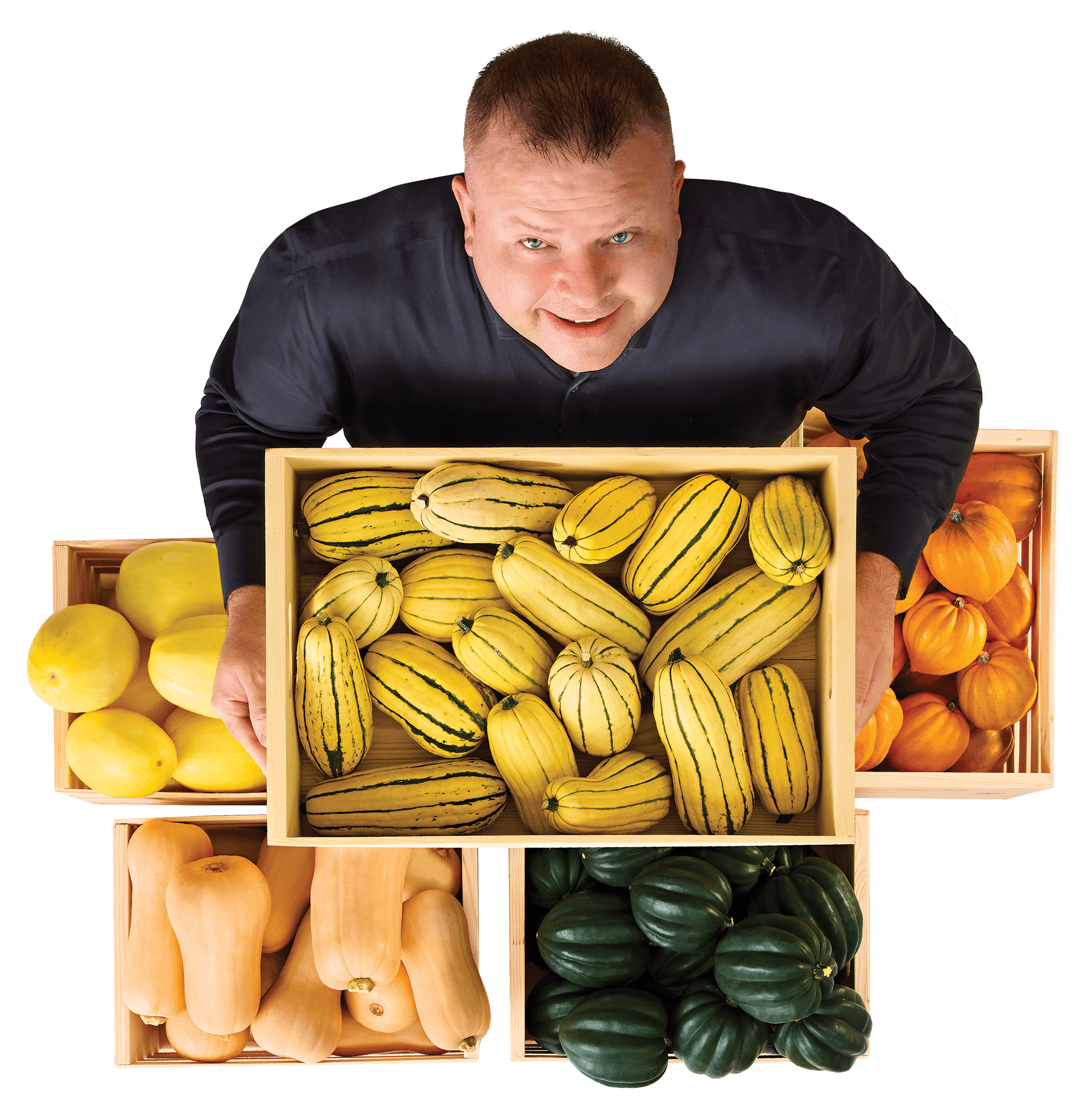An image of Jeff Mallory, Vice President, Produce, holding a wood crate box with delicata squash.
