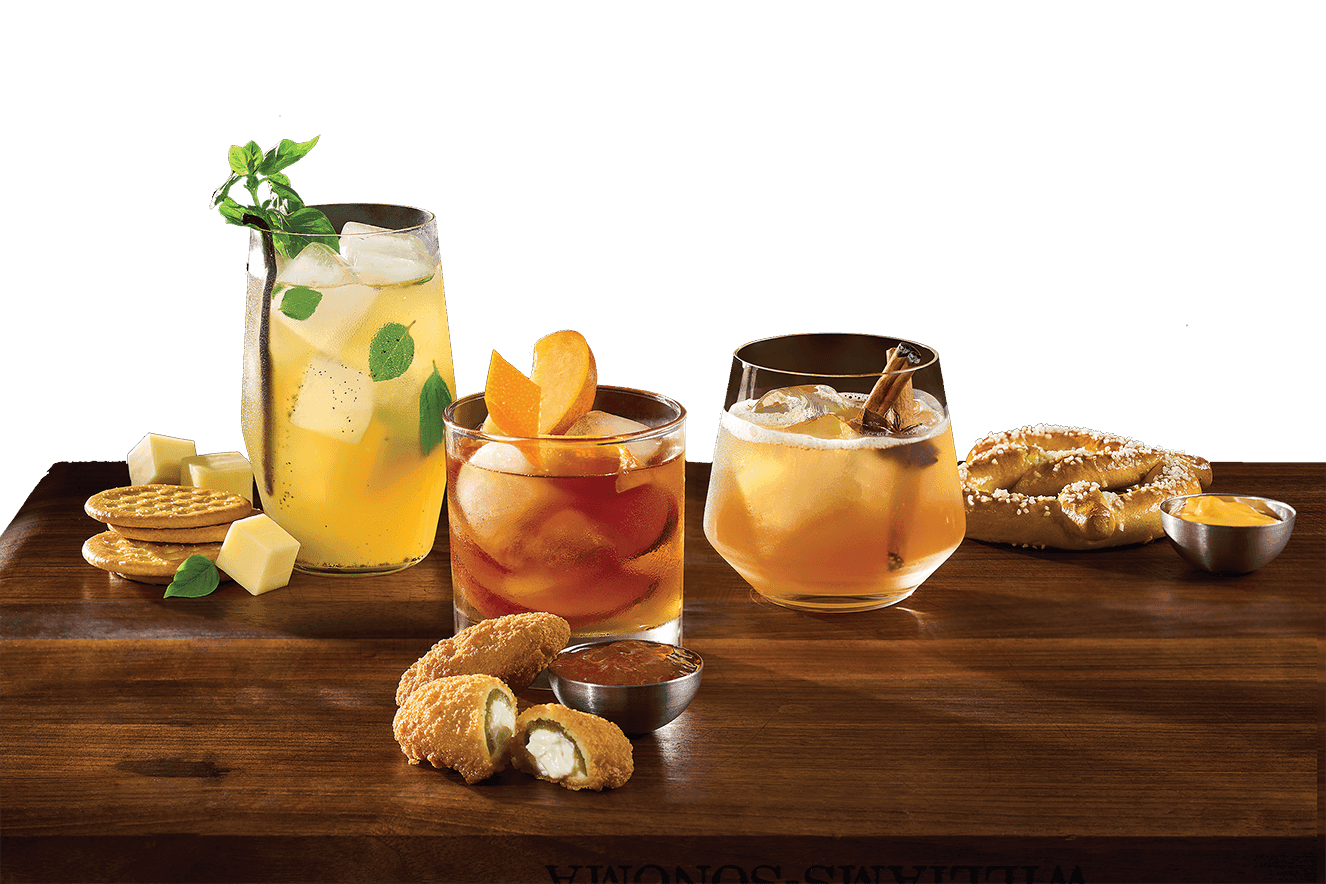 Vanilla Bourbon Cocktail, Chai Ginger Bourbon Cocktail & Peach Old Fashioned on a table next to Crav'n Crackers, Cream Cheese stuffed jalapeno poppers and Soft Pretzel